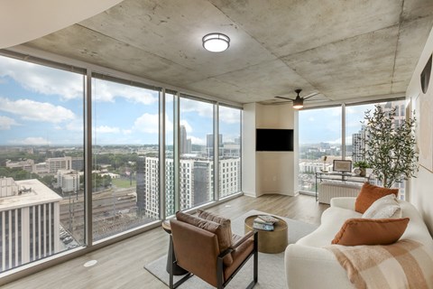 a living room with a white couch and a large window